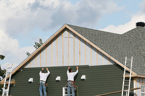 Professional Vinyl Siding technician working in Cortland, NY